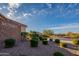 View of community entrance with appealing greenery and clear blue sky at 8180 W Silver Spring Way, Florence, AZ 85132