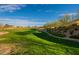 Scenic view of the community park with lush green grass, native trees, and clear blue skies at 8180 W Silver Spring Way, Florence, AZ 85132