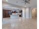 Open-concept living room connected to the kitchen featuring tiled floors at 8180 W Silver Spring Way, Florence, AZ 85132