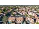 An aerial view showcasing a neighborhood with pools, mature trees, and well-maintained properties at 819 W Kyle E Ct, Gilbert, AZ 85233