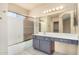 Bathroom featuring a shower-tub combo, large mirror, and vanity at 819 W Kyle E Ct, Gilbert, AZ 85233