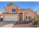 Charming two-story home featuring a tile roof, two car garage and low maintenance desert landscaping at 819 W Kyle E Ct, Gilbert, AZ 85233