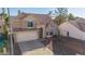 Two-story home with a tile roof, attached garage, and a well-manicured front yard on a sunny day at 819 W Kyle E Ct, Gilbert, AZ 85233