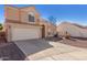 Charming two-story home featuring a tile roof, two car garage and low maintenance desert landscaping at 819 W Kyle E Ct, Gilbert, AZ 85233