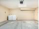 Spacious garage area with a washer and dryer, offering ample room for parking and storage at 819 W Kyle E Ct, Gilbert, AZ 85233