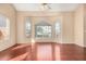 Bright living room featuring hardwood floors and three large windows at 819 W Kyle E Ct, Gilbert, AZ 85233