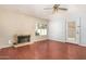 Living room showcases a ceiling fan, fireplace, and view to the back yard at 819 W Kyle E Ct, Gilbert, AZ 85233