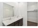 Bathroom with dual sinks and granite countertops, accompanied by a well-lit vanity mirror and storage at 8452 W Clemente Way, Florence, AZ 85132