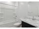 A well-lit bathroom featuring a shower-tub combo and vanity with a marble countertop at 8452 W Clemente Way, Florence, AZ 85132