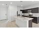 Modern kitchen with stainless steel appliances, a marble island and dark cabinetry offers both style and functionality at 8452 W Clemente Way, Florence, AZ 85132