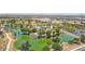 Aerial view of a pond with a walking path, playground, and lush green landscaping at 8452 W Clemente Way, Florence, AZ 85132