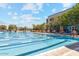 Exterior view of a large swimming pool with lap lanes, lounge chairs, and a clubhouse at 8452 W Clemente Way, Florence, AZ 85132