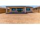 Spacious backyard featuring a covered patio and large sliding glass doors leading into the home at 8553 N 175Th Ln, Waddell, AZ 85355