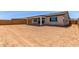 View of the home's backyard with a covered patio, sliding glass doors, and enclosed brick fence at 8553 N 175Th Ln, Waddell, AZ 85355