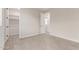 Neutral bedroom includes tile flooring, closet, and view to laundry area, offering a clean and spacious layout at 8553 N 175Th Ln, Waddell, AZ 85355