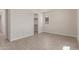 Well-lit bedroom features wood-look tile flooring, window, and an open doorway to the closet at 8553 N 175Th Ln, Waddell, AZ 85355