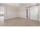 Spacious bedroom with a sliding barn door leading to the bathroom and wood-look tile flooring at 8553 N 175Th Ln, Waddell, AZ 85355
