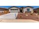 Inviting single-Gathering home features desert landscaping, neutral stucco and a two car garage at 8553 N 175Th Ln, Waddell, AZ 85355