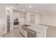 Bright kitchen with stainless steel appliances, a farmhouse sink, and granite countertops on the island at 8553 N 175Th Ln, Waddell, AZ 85355
