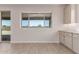 Bright kitchen features white cabinets and a window view of the backyard at 8553 N 175Th Ln, Waddell, AZ 85355