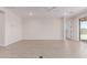 Neutral living room featuring tile floors and access to the backyard at 8553 N 175Th Ln, Waddell, AZ 85355