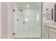 Sleek walk-in shower featuring a glass enclosure, rainfall shower head, and built-in bench at 8553 N 175Th Ln, Waddell, AZ 85355