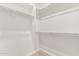 Large walk-in closet offers ample storage with shelving, and hanging rods for organized wardrobe at 8553 N 175Th Ln, Waddell, AZ 85355
