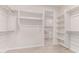 Spacious walk-in closet featuring ample shelving and hanging rods, plus access to the laundry area at 8553 N 175Th Ln, Waddell, AZ 85355