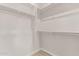Large walk-in closet offers ample storage with shelving, and hanging rods for organized wardrobe at 8553 N 175Th Ln, Waddell, AZ 85355