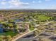Stunning aerial view of the community, featuring a lake, parks, walking paths, and mountain views at 8554 W Trenton Ct, Florence, AZ 85132