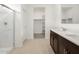 Modern bathroom with tiled floors, walk-in shower, double sink vanity, and bright natural light at 8554 W Trenton Ct, Florence, AZ 85132