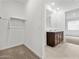 Spacious walk-in closet with a double-sink vanity and adjacent hanging rack at 8554 W Trenton Ct, Florence, AZ 85132
