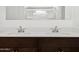Close-up view of the stylish bathroom featuring a double vanity with sleek countertops and modern fixtures at 8554 W Trenton Ct, Florence, AZ 85132