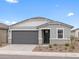Charming single-story home with gray stucco, well-manicured landscaping, and a two-car garage at 8554 W Trenton Ct, Florence, AZ 85132