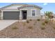 Charming single-story home with gray stucco, brick accents, with low maintenance desert landscaping at 8554 W Trenton Ct, Florence, AZ 85132