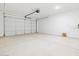 Spacious garage with concrete floors, white walls, automatic door, and ample room for parking and storage at 8554 W Trenton Ct, Florence, AZ 85132