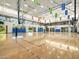 Bright gymnasium featuring basketball courts and volleyball nets, ideal for various recreational activities at 8554 W Trenton Ct, Florence, AZ 85132