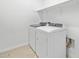 Bright laundry area with modern washer, dryer, storage shelves and neutral flooring at 8554 W Trenton Ct, Florence, AZ 85132