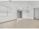 Open living area with tile floors, recessed lighting, and sliding glass door at 8554 W Trenton Ct, Florence, AZ 85132
