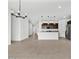 Open concept with tile flooring, modern lighting fixtures, kitchen, and stainless appliances at 8554 W Trenton Ct, Florence, AZ 85132