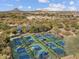 Aerial view of multiple pickleball courts, showing the layout and a beautiful desert neighborhood at 8554 W Trenton Ct, Florence, AZ 85132