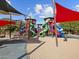 A colorful playground features multiple slides, towers, and shaded areas for fun at 8554 W Trenton Ct, Florence, AZ 85132