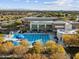 A long swimming pool with blue lounge chairs and sun umbrellas, ideal for relaxation and recreation at 8554 W Trenton Ct, Florence, AZ 85132