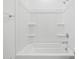 Clean shower-tub combination with white tile and chrome fixtures for a modern look at 8554 W Trenton Ct, Florence, AZ 85132