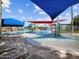 Vibrant splash pad with colorful water features, loungers and umbrellas, perfect for Gathering fun at 8554 W Trenton Ct, Florence, AZ 85132