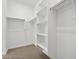 Well-organized walk-in closet with shelving and multiple hanging rods for ample storage at 8554 W Trenton Ct, Florence, AZ 85132