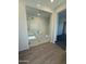 Luxurious bathroom with glass-enclosed shower, bench, and modern tiling at 8561 N 175Th Ln, Waddell, AZ 85355