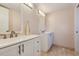 Stylish bathroom with dual vanities, mirrors, and tile flooring at 8626 N 50Th Ln, Glendale, AZ 85302