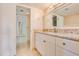 Bright bathroom with a granite countertop, white cabinets, and a large mirror at 8626 N 50Th Ln, Glendale, AZ 85302