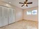 Bedroom with a ceiling fan, tile flooring, and a large closet at 8626 N 50Th Ln, Glendale, AZ 85302